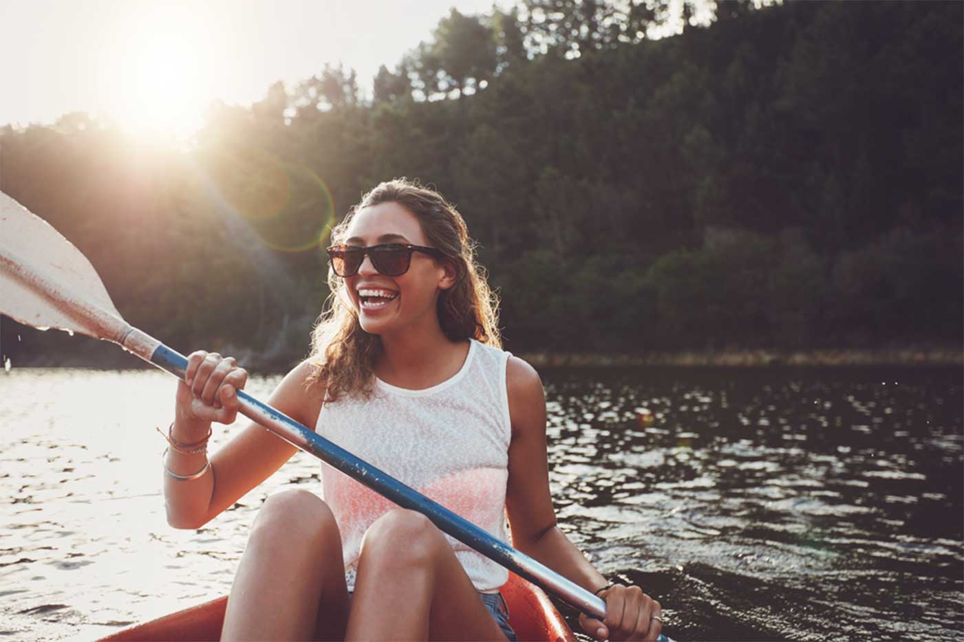 woman kayaking at an emotional health retreat center